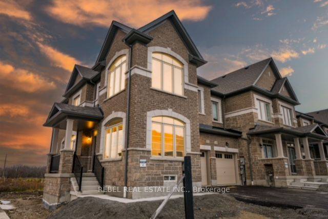 Welcome to 1251 Rexton Dr, North Oshawa a newly built freehold end unit townhome on a premium corner lot overlooking a pond w beautiful walking trails to the south.