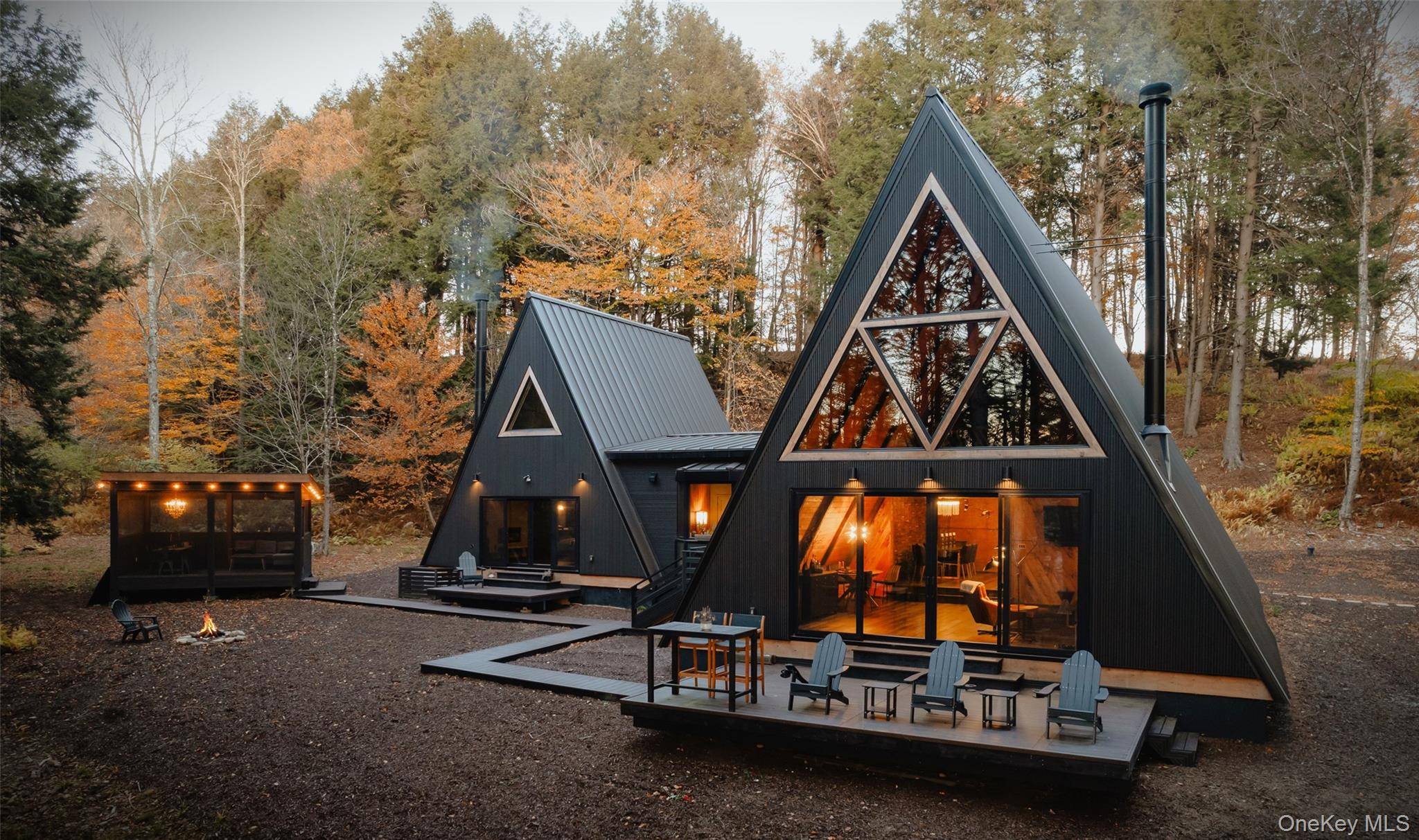 Escape to your own private woodland getaway in this striking double A frame home, custom designed by a local builder known for creating spaces rich in character and textures.