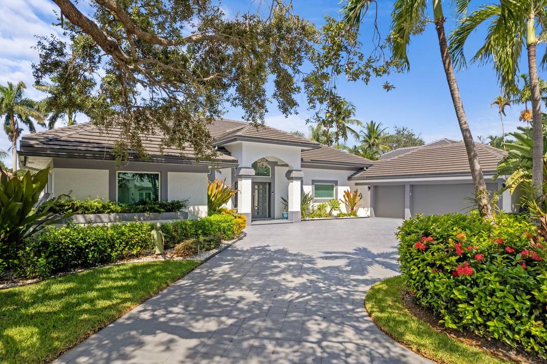 This exquisitely renovated, turn key residence in Bear Lakes Estates sits on a lushly landscaped half acre lot in one of West Palm Beach's most prestigious gated golf communities.