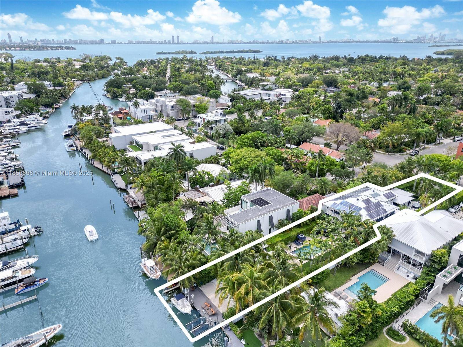 Renovated, elevated, and gated waterfront estate in guard patrolled Belle Meade.
