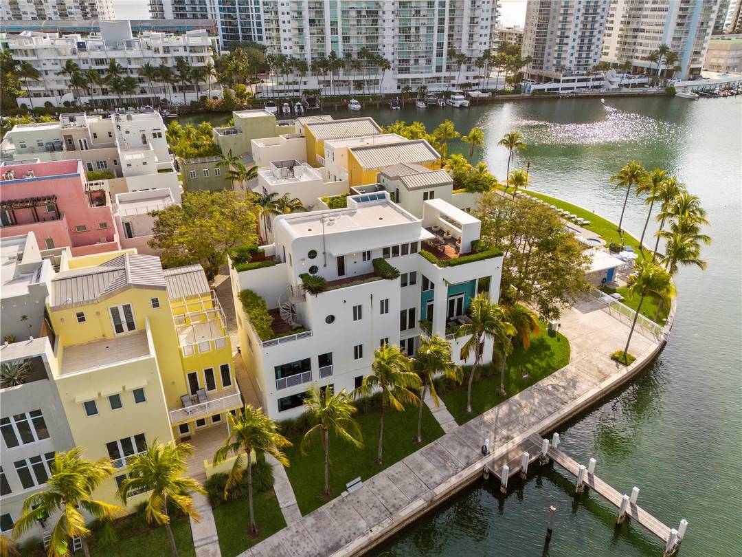Experience elevated Miami Beach living in this luxurious 4 story townhouse located in one of the area s most exclusive gated waterfront communities.