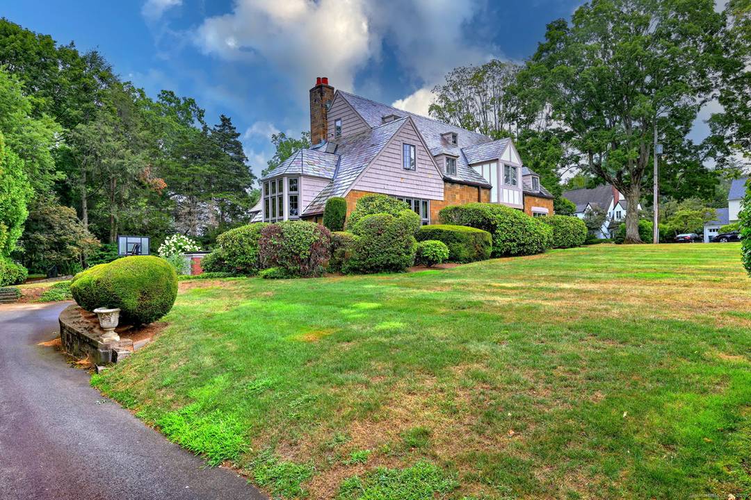 Elegant 1928 Tudor inspired Colonial in the heart of Spring Glen, gracefully set on a professionally landscaped 1 2 acre corner lot with undeniable curb appeal.