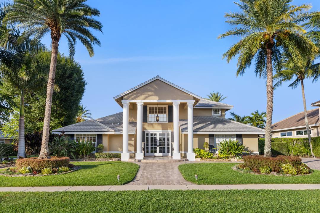 Enjoy lakefront sunsets from this elegant home in the gated community of Polo West, near Wellington International.