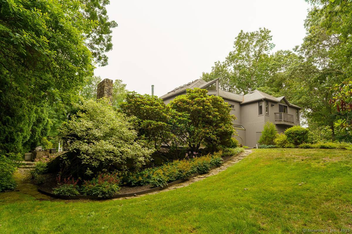 Nestled in the tranquil and coastal enclave of Mason's Island, this stunning residence sits amid tall pines and winding streets just moments from the heart of downtown Mystic.