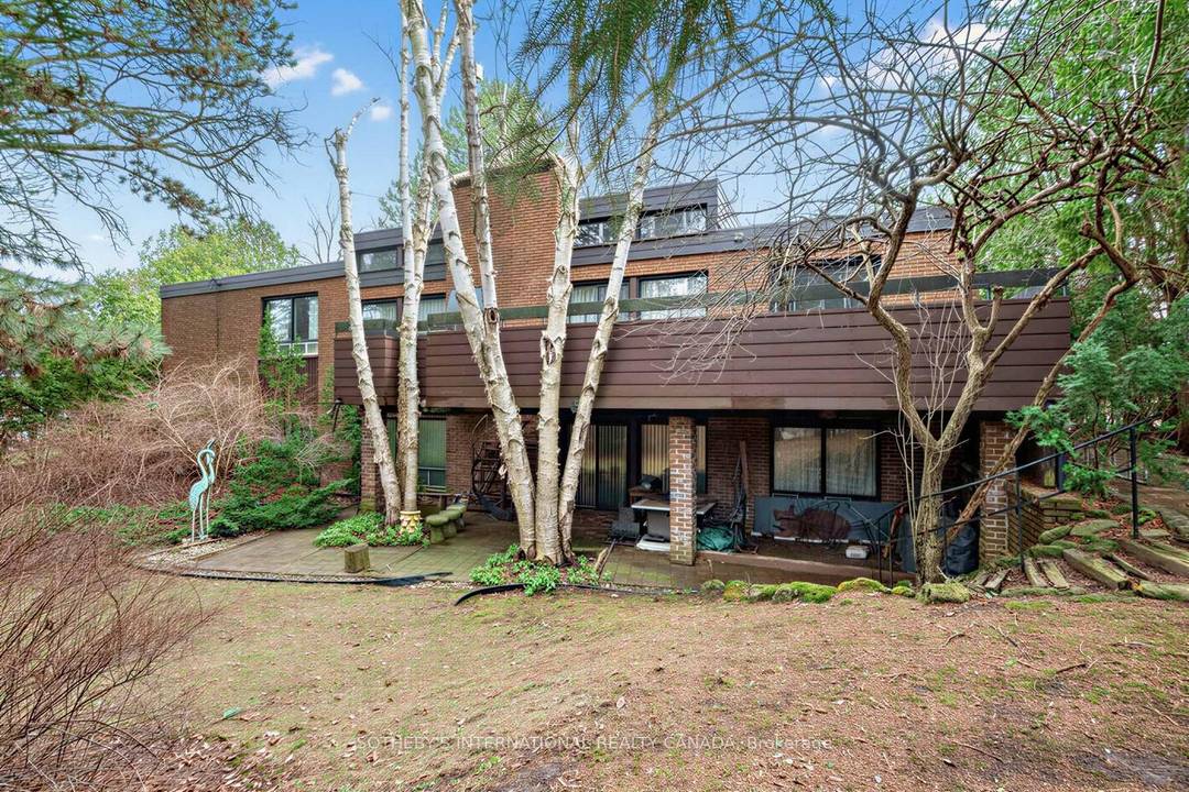 Tucked into a serene, tree lined setting in prestigious Bridle Path area this architecturally distinctive bungalow offers exceptional scale, privacy, and opportunity customize, renovate, or build new.