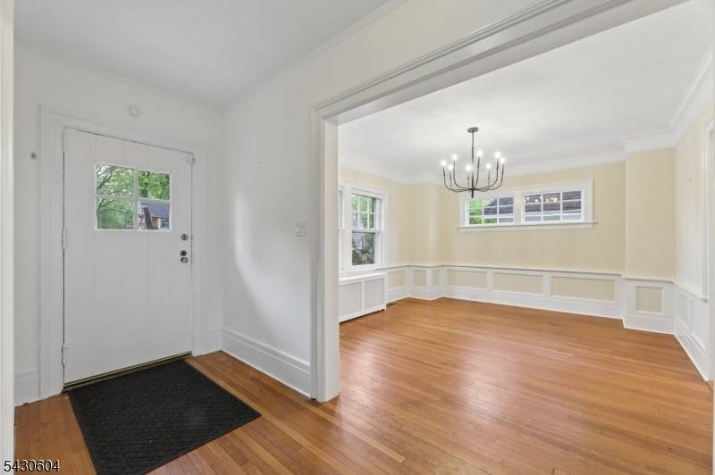 Set back on a deep, private property on a wide, quiet street in Montclair's sought after Woods section, this sunny and spacious center hall Colonial is full of charm.