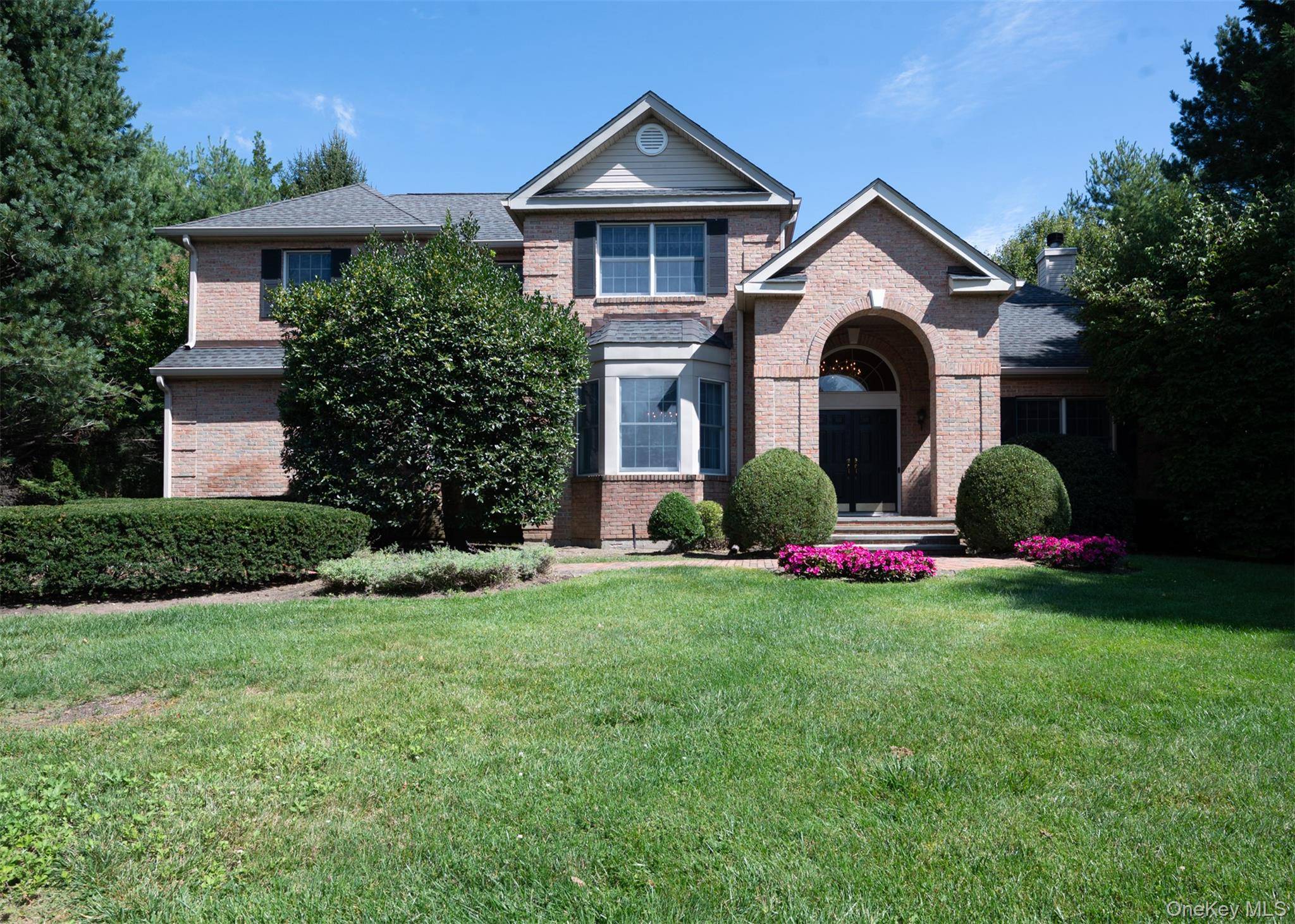 Secluded, inviting and perfectly appointed, this five bedroom brick front colonial on a lushly landscaped acre property offers an exceptional lifestyle in the coveted Half Hollow Hills School District.