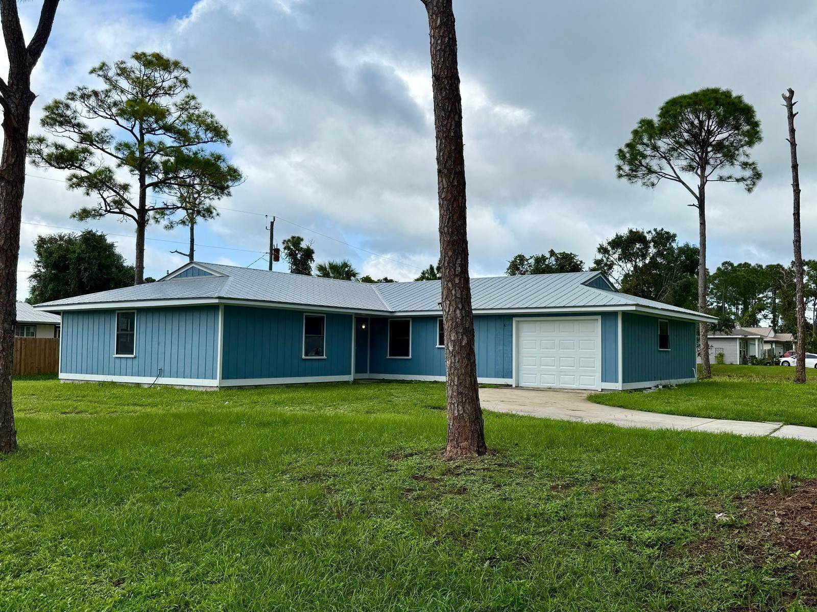 Discover the potential in this 3 bedroom, 2 bath single family home with a 1 car garage, perfectly situated on a desirable corner lot in Fort Pierce.