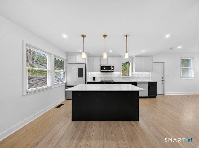 This stunningly renovated 4 bedroom 3 bathroom home offers a perfect blend of modern luxury and functional design, featuring an open concept kitchen with an island, waterfall countertops, and high ...