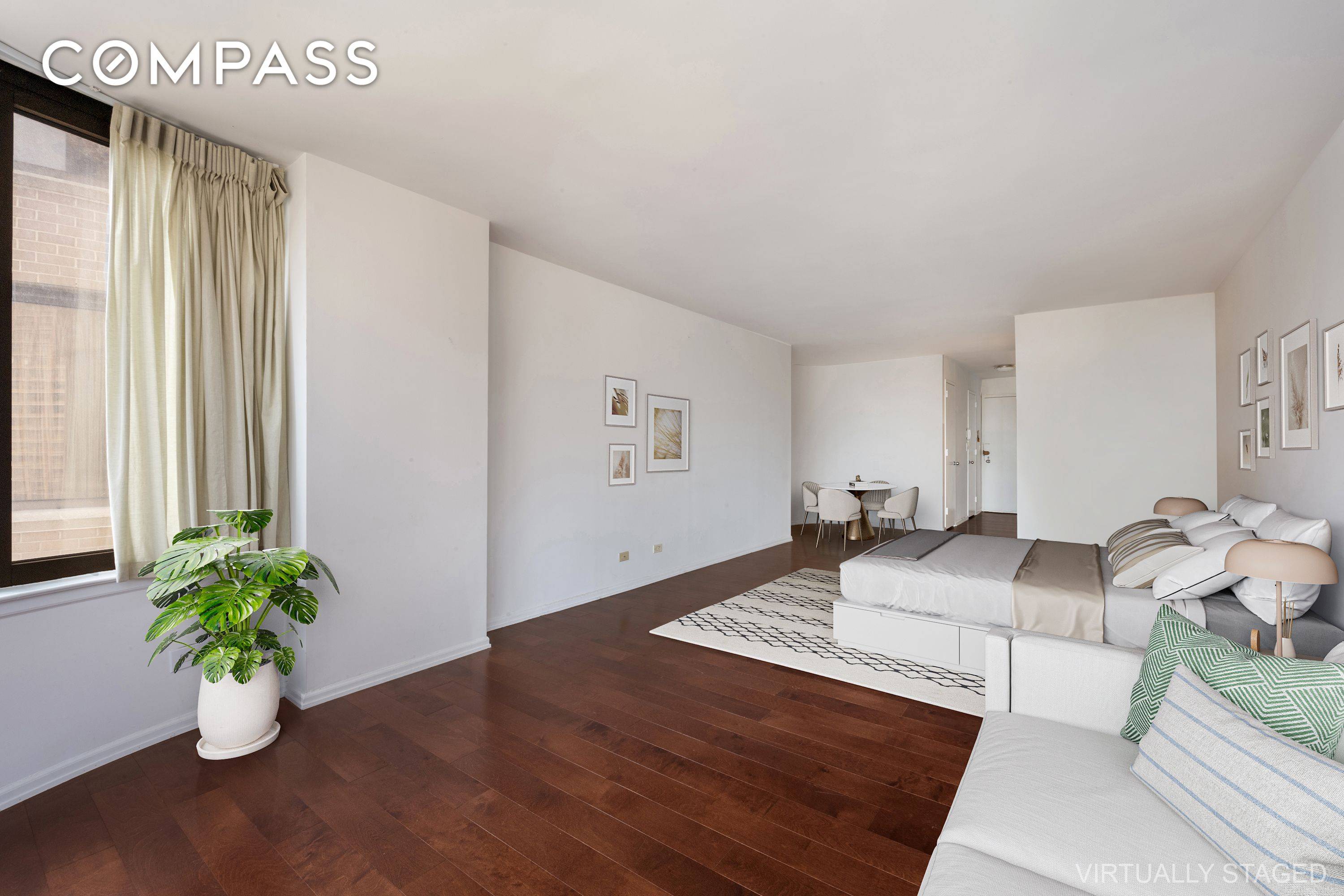 Midtown East studio in a full service doorman condo with spectacular open city and water views.