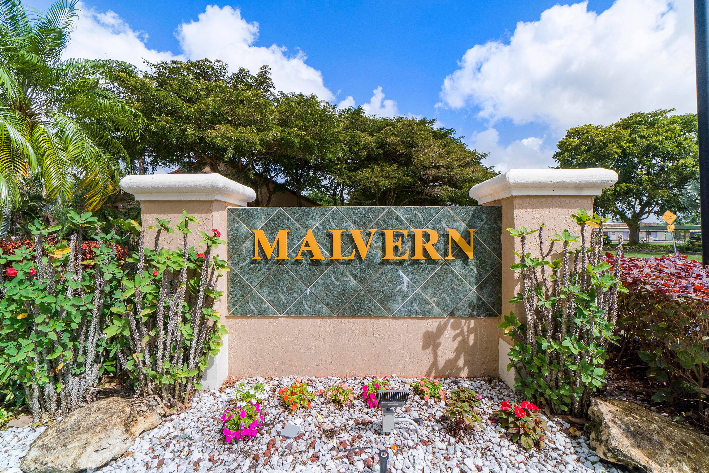 CORNER VILLA FEATURING TWO BEDROOMS, TWO BATHROOMS, A DEN, AND AN ATTACHED GARAGE.