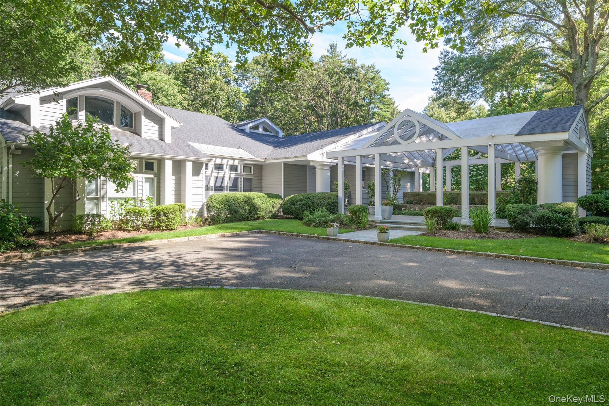 OLD WESTBURY MASTERPIECE Welcome to this magnificent 6000sqft Hamptons style residence set on two beautifully landscaped acres on a private cul de sac within the highly sought after Jericho School ...