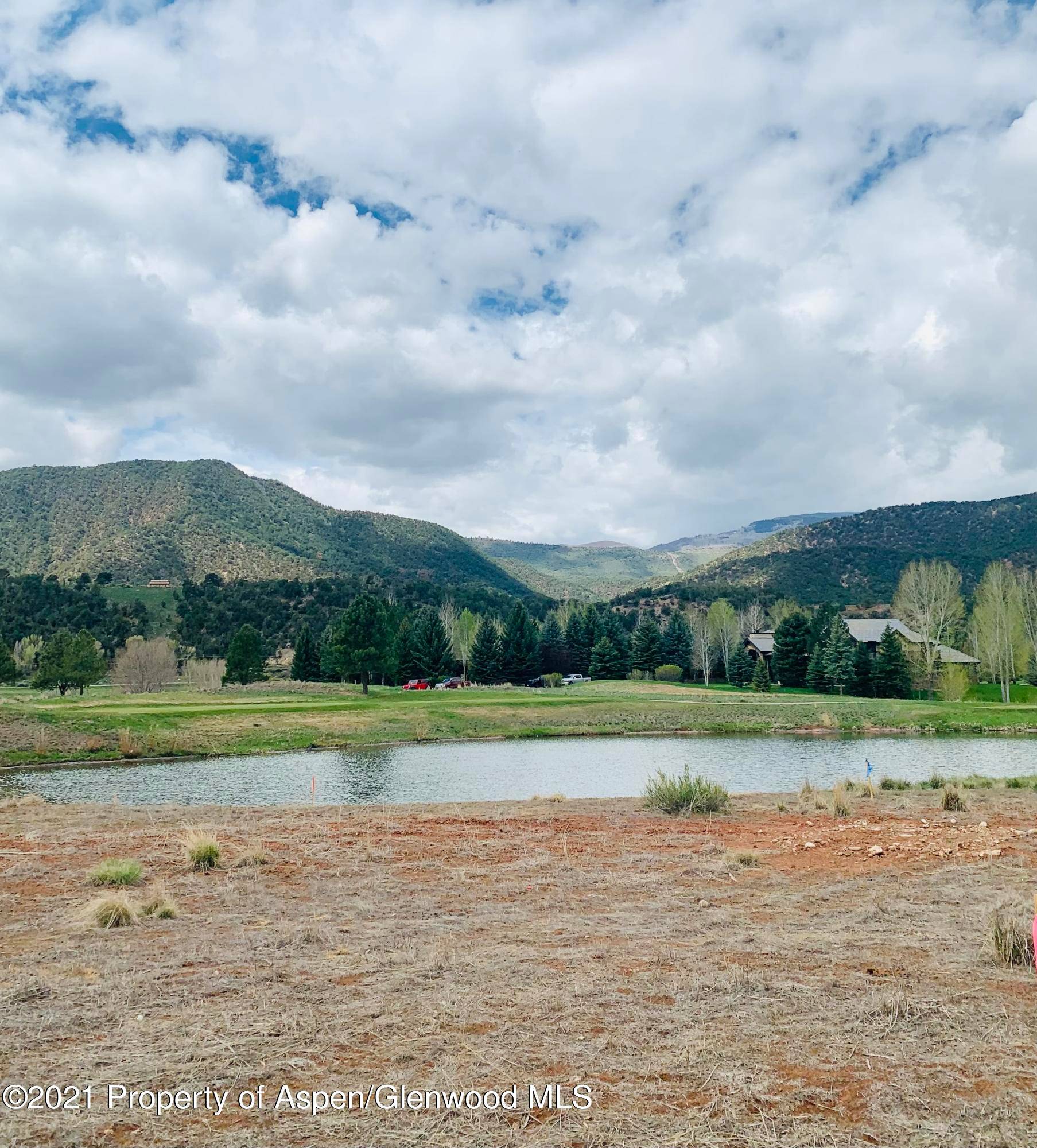 Wonderful flat lot adjacent to the pond on the 16th tee box.