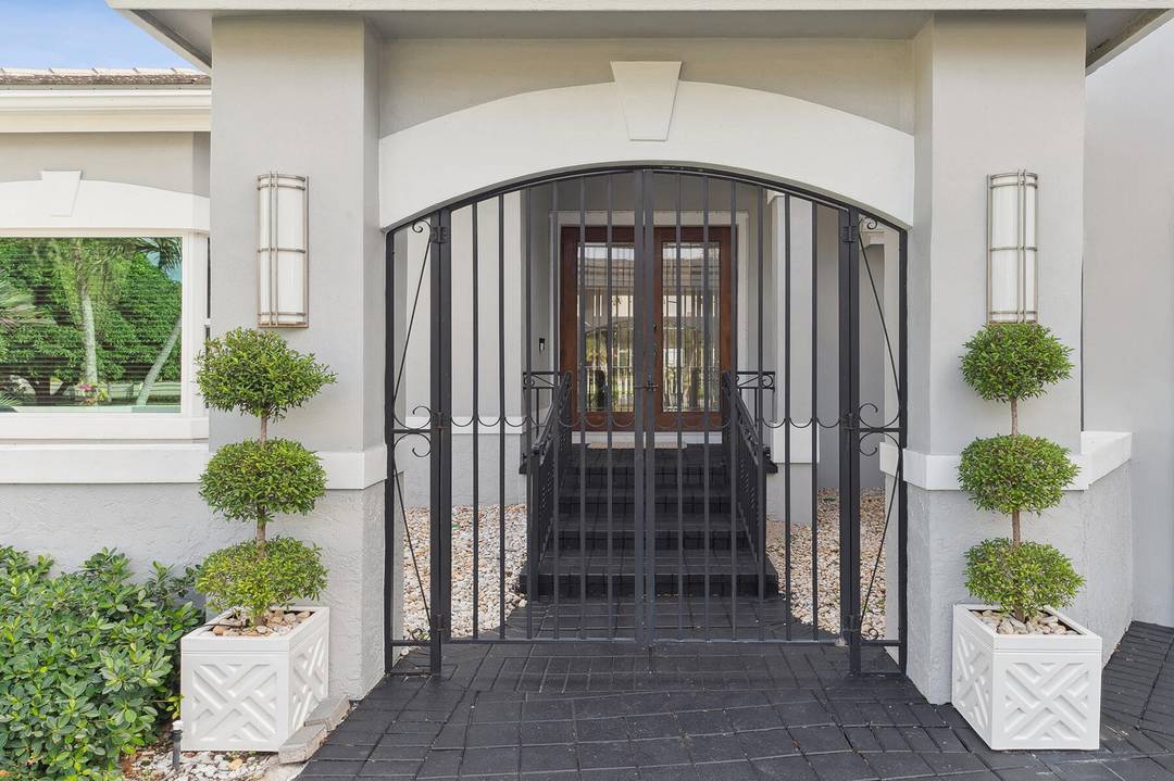 Bring your cherished antique and collectible cars to this spectacular contemporary residence, perfectly tucked away on a peaceful cul de sac overlooking the sparkling waters of Lake Mangonia.