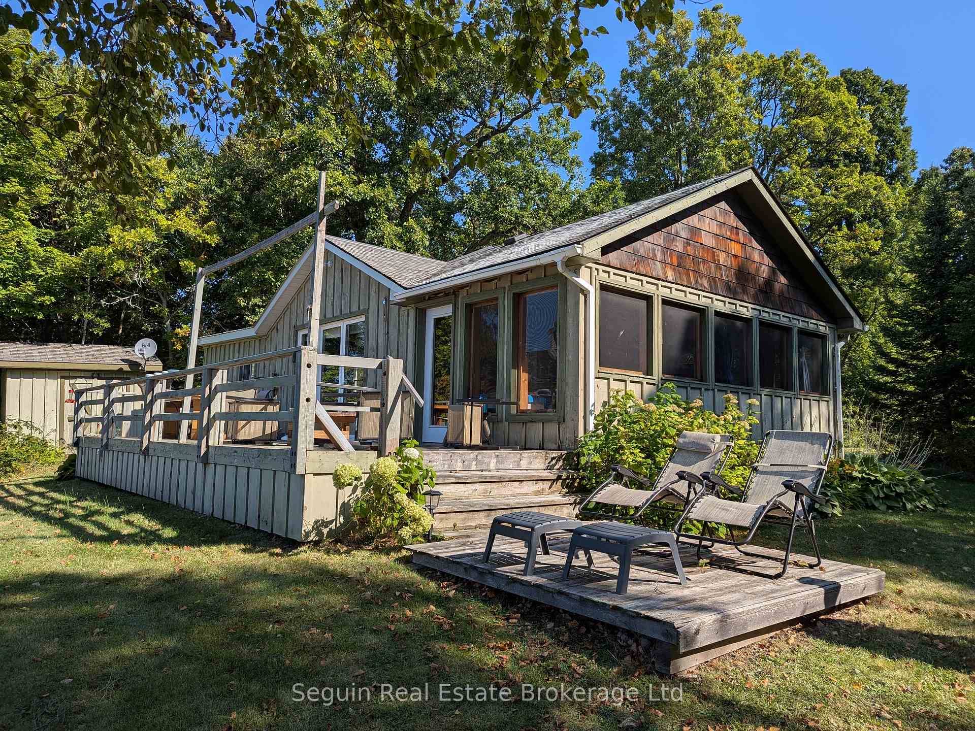 West facing and completely private custom country cottage on 1 acre with 300' of smooth rock Canadian Shield shoreline.