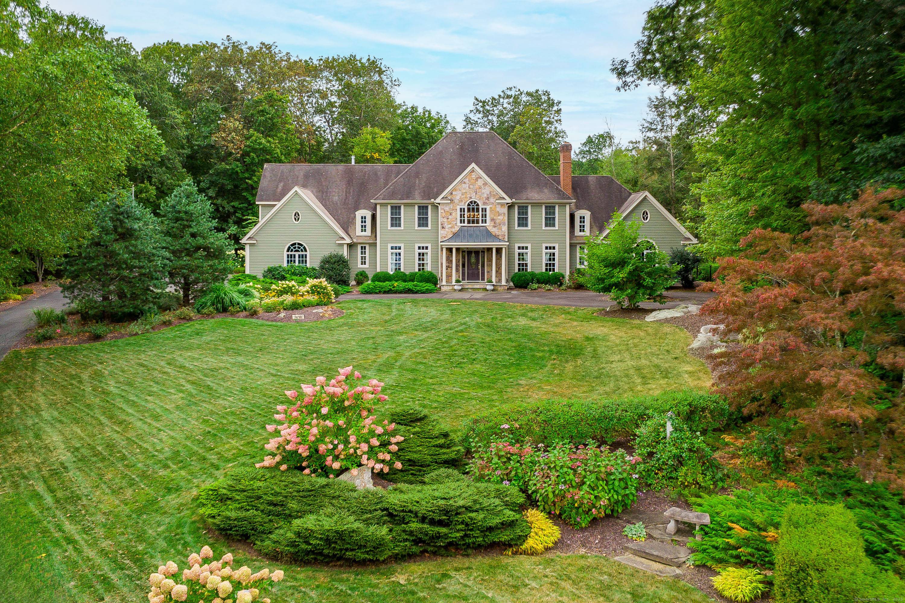 Nestled at the end of a peaceful cul de sac, this stunning home offers access to the scenic trails of Paugussett State Forest.