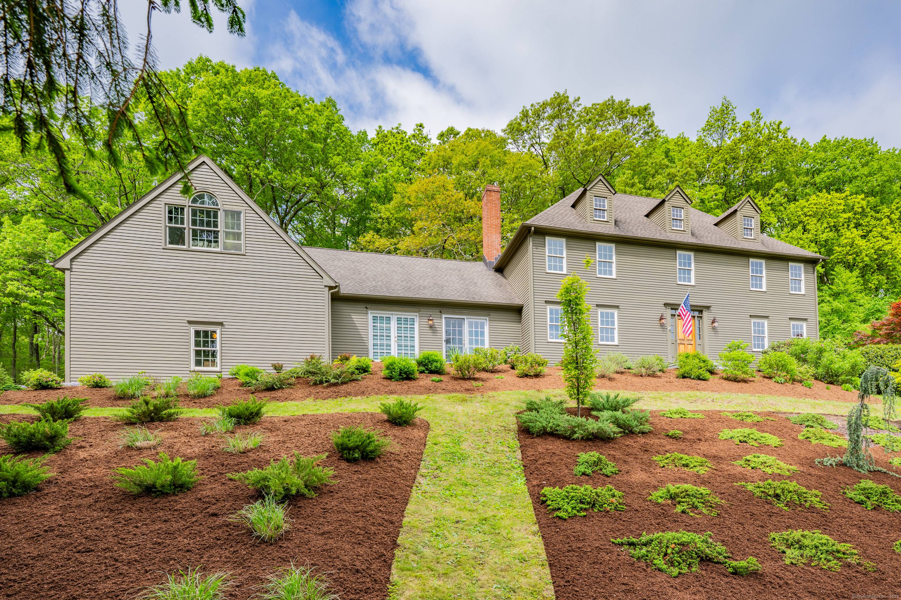 Beautifully constructed and perched atop a scenic 3 acre lot, this stately gambrel colonial is just a 5 minute drive from charming downtown Woodbury.