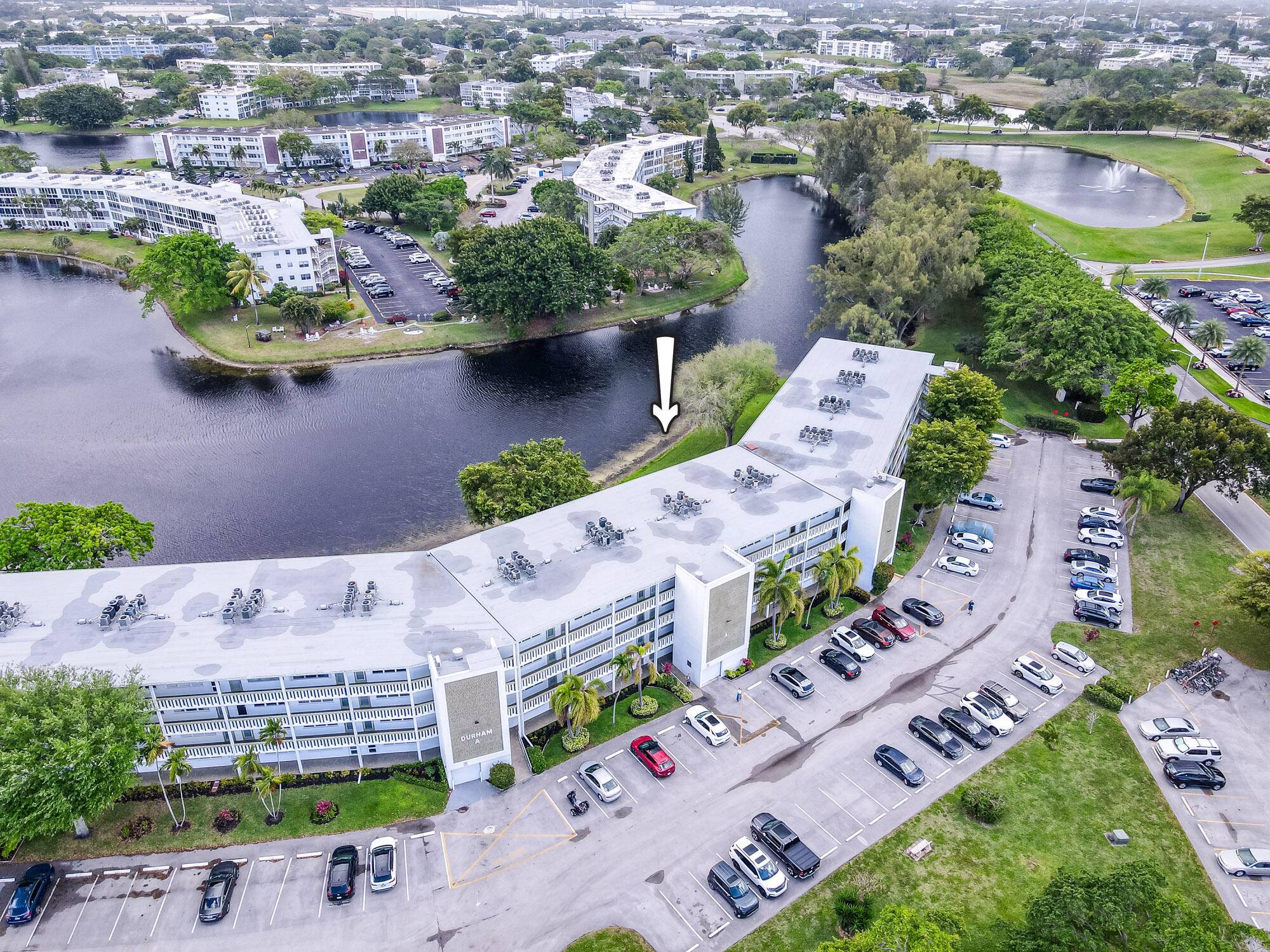 Recently renovated modern condo with new kitchen cabinets, flooring, glass backsplash, and new appliances.