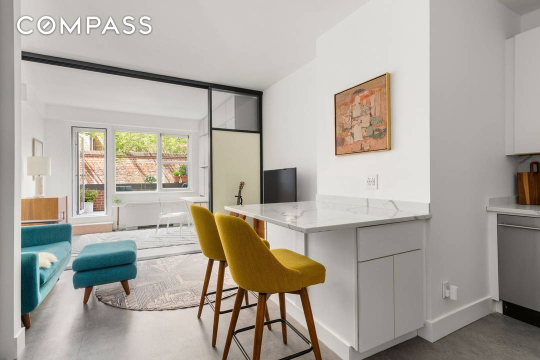Welcome to the most ideal studio junior one bedroom featuring an opaque sliding panel seperated bedroom with a custom built in murphy bed desk built in storage, a beautifully renovated ...