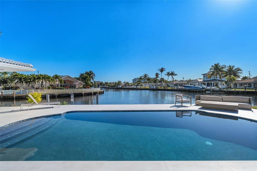 Fully renovated modern waterfront residence in Pompano Beach offering over 110 feet of waterfront with ocean access via one fixed bridge at Federal Hwy, approximately 14 clearance at low tide.