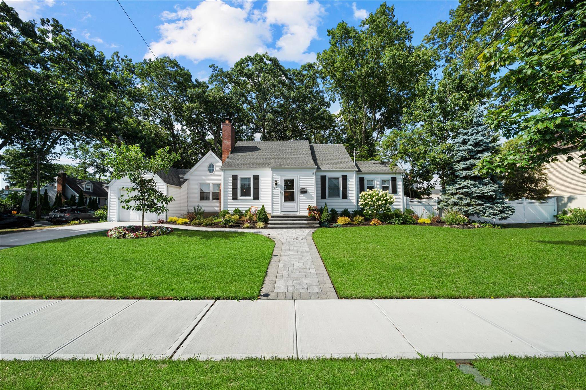 Beautiful expanded Cape style home featuring 4 spacious bedrooms, 2 full bathrooms, and a full finished basement perfect for additional living space or entertaining.