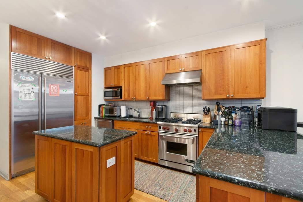 Spectacular owner's triplex with private south facing garden with huge storage shed.