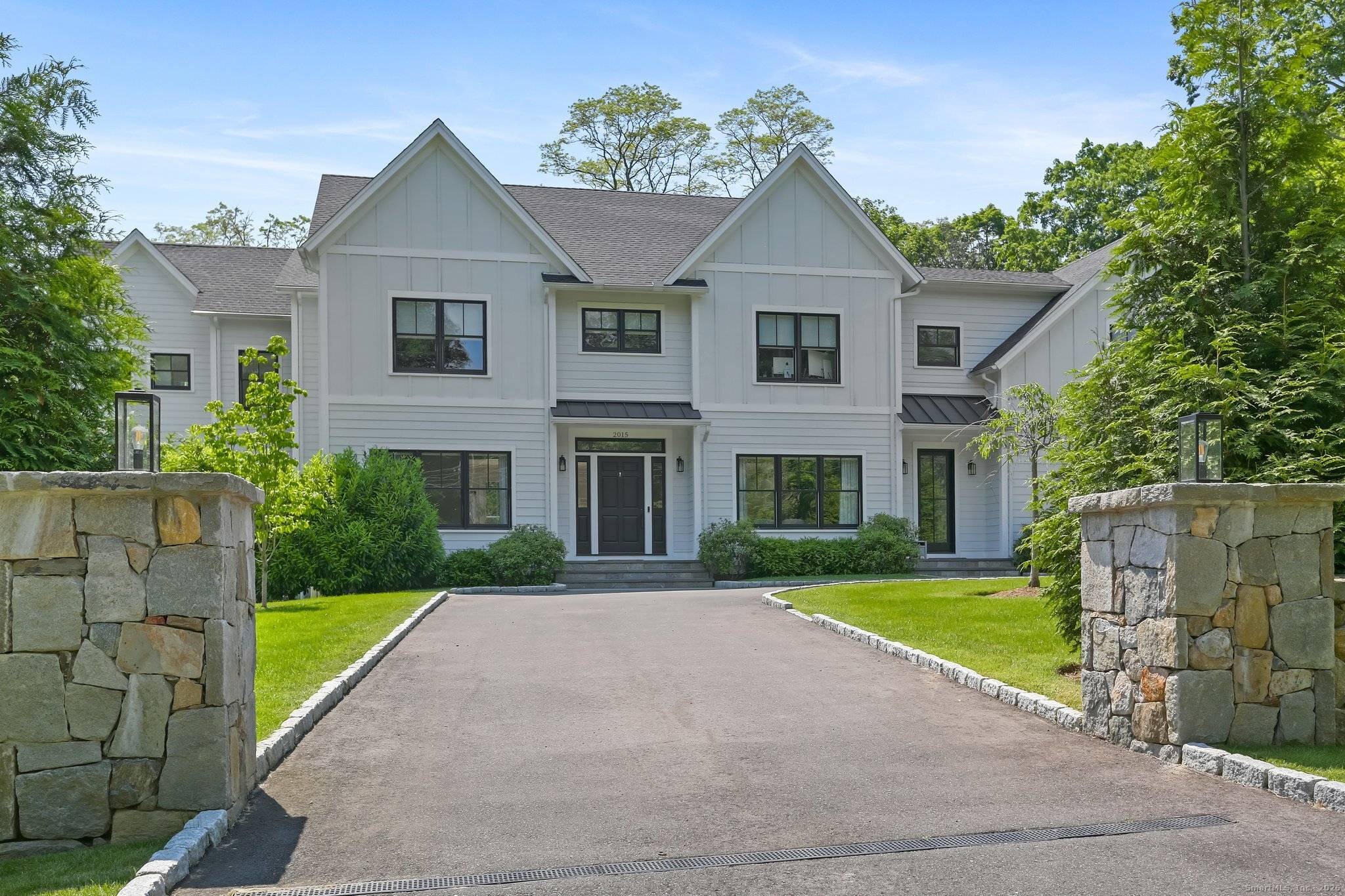 Majestically sited on 2 private acres of professionally landscaped grounds, this exceptional SMART modern farmhouse surpasses new construction standards with uncompromising attention to detail.
