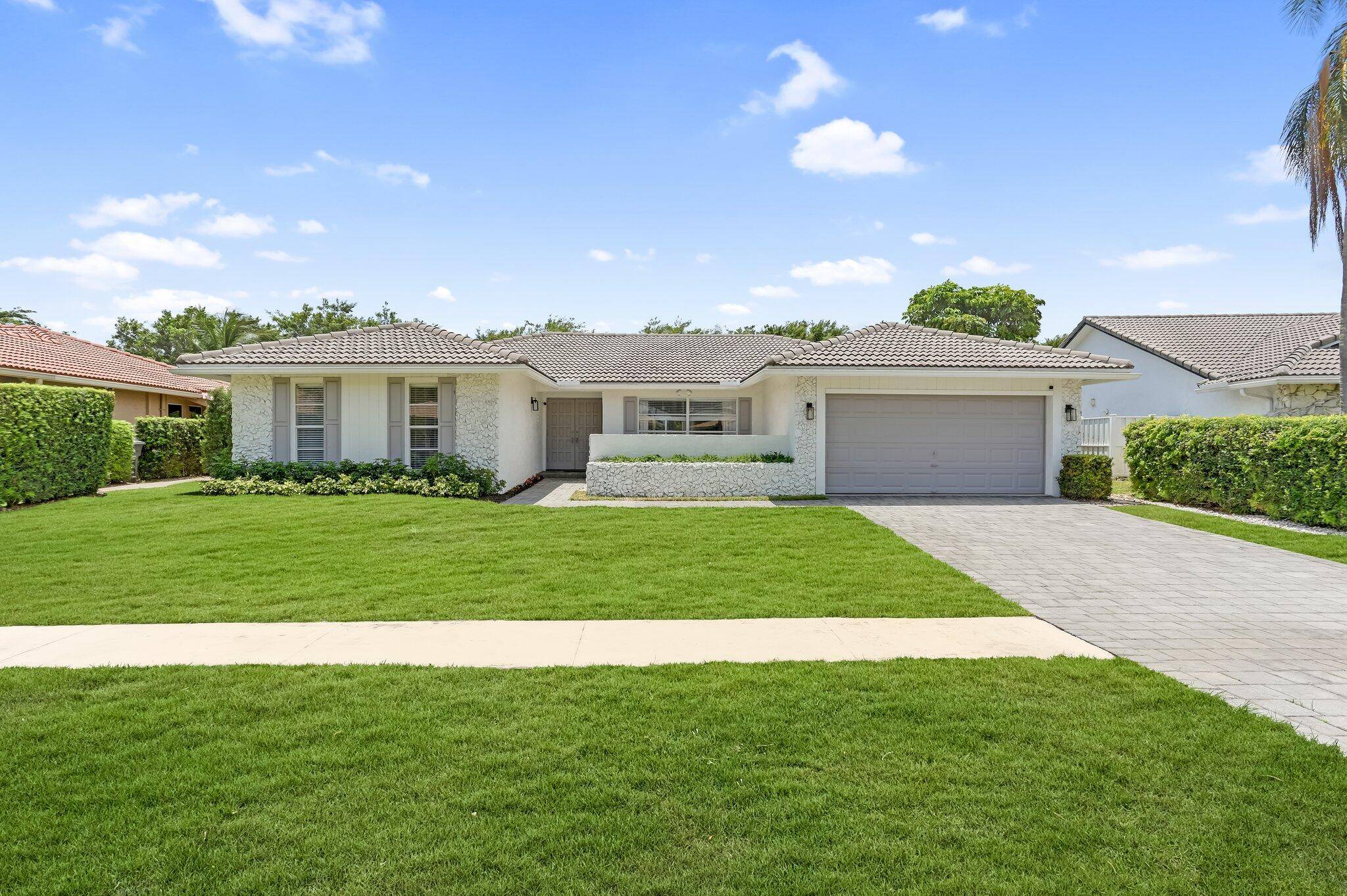 Step into elevated South Florida living with this fully remodeled showpiece in the exclusive, gated enclave of Boca Greens a vibrant, family friendly community.