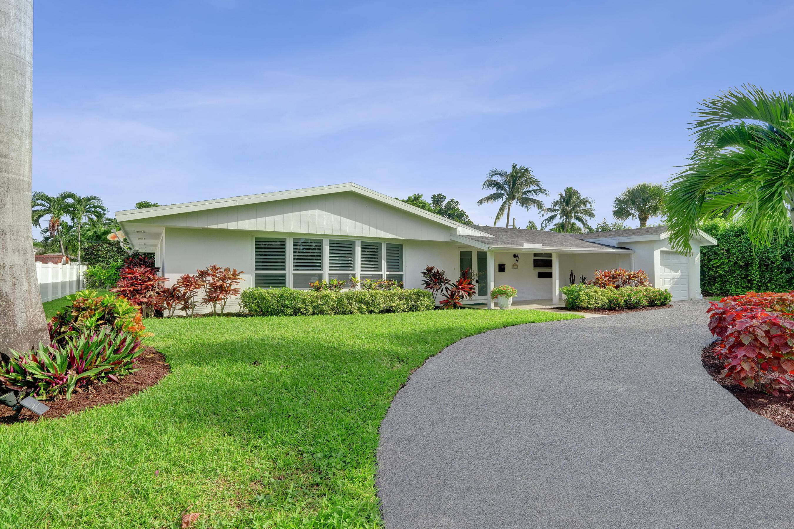 This exquisite three bedroom two bath pool home captures the true essence of East Boca living, perfectly positioned on a peaceful street just minutes from the Atlantic Ocean.