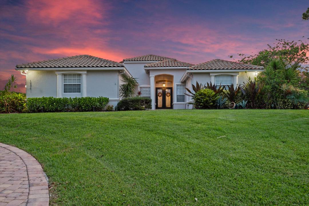 Elegant lakefront estate nestled in a tranquil cul de sac, offering sweeping sunset views over a private 20 acre lake.