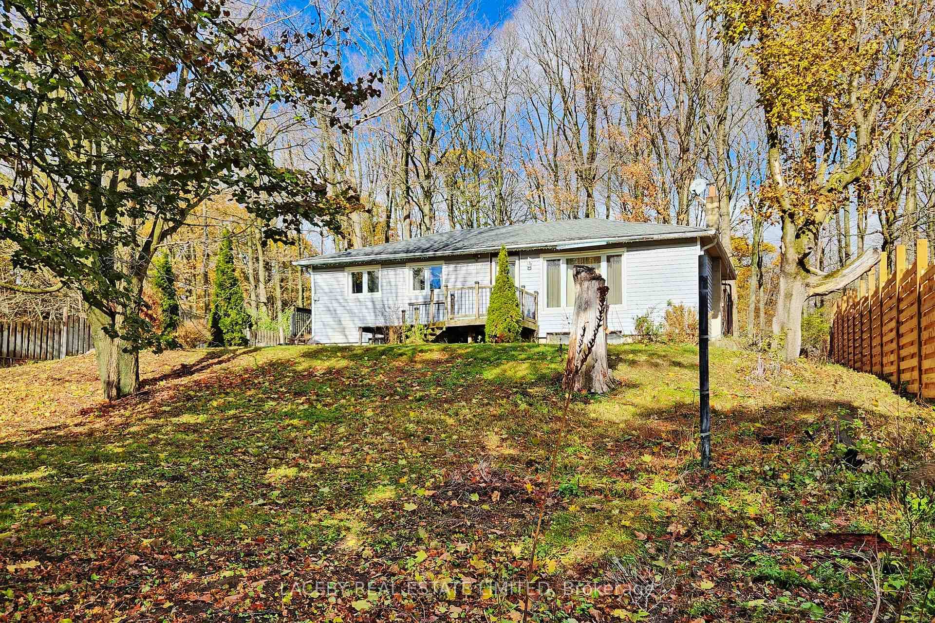 Beautiful 0. 75 acre treed property with a 3 bedroom bungalow, detached two car garage workshop with a separate furnace and 1 bedroom contained in law suite above.