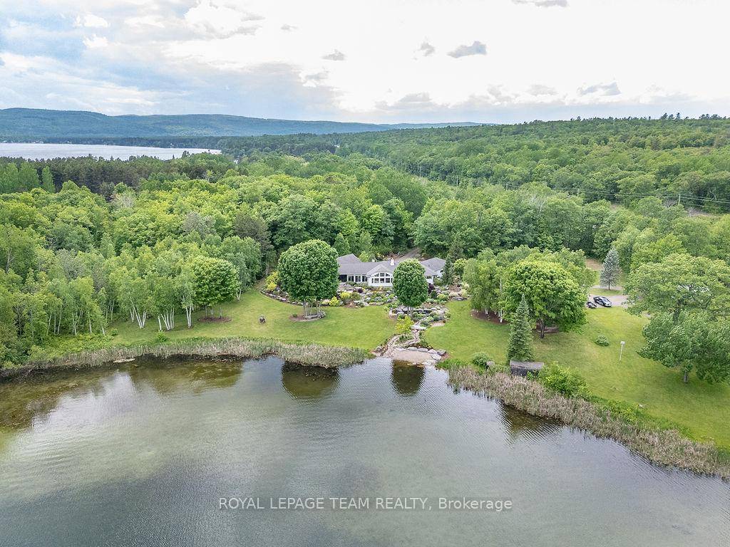 Luxury Executive Estate on Little Lake Clear Featuring a Heated Indoor Pool, Hot Tub amp ; 5 Private Acres on sought after Little Lake Clear.