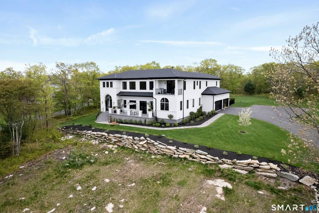 Perched atop a scenic ridge in Glastonbury, this Mediterranean inspired estate offers breathtaking panoramic views, including the Connecticut State Capitol, with seamless indoor outdoor living.