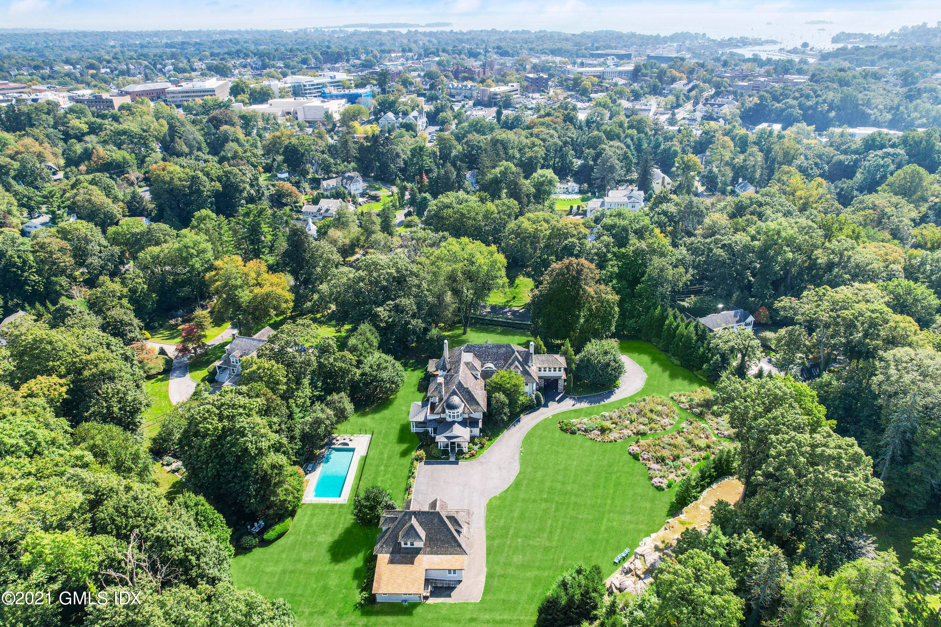 Stroll to town from this fully renovated Greenwich estate, majestically sited on 3.