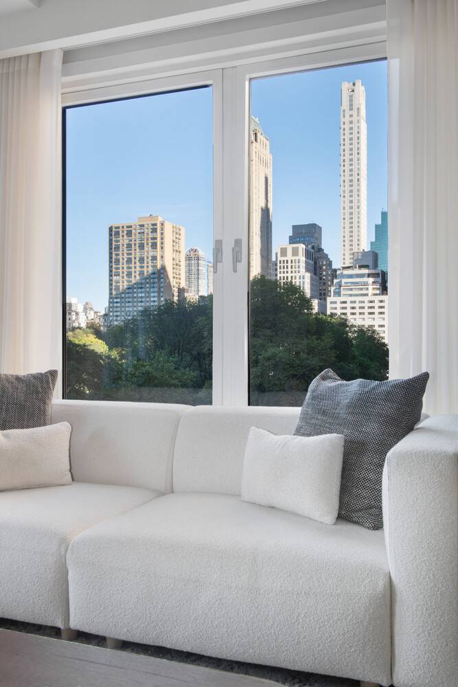 Oversized picture windows frame postcard perfect views of Central Park from every room in this elegantly renovated home.