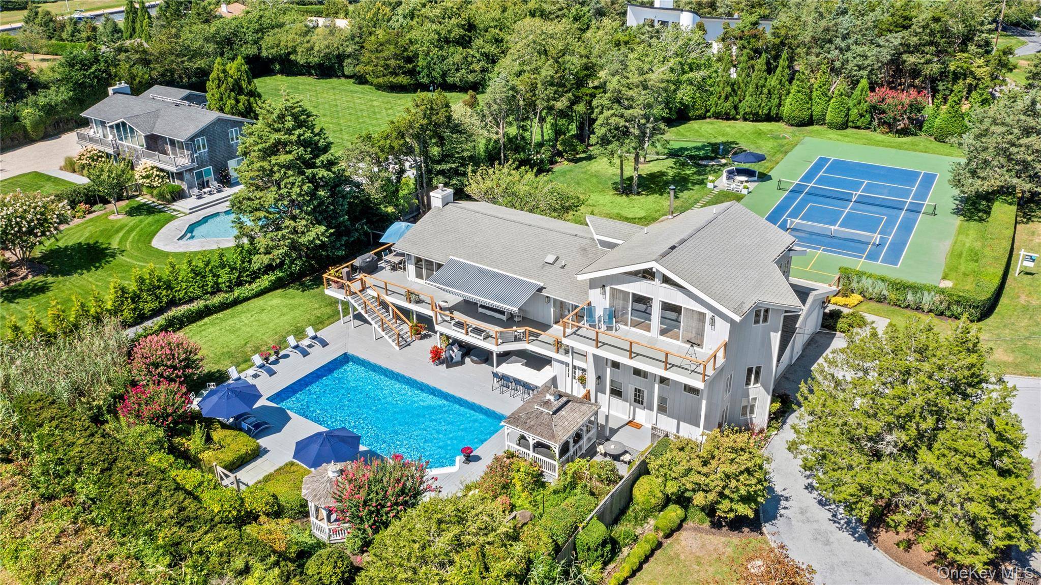 Welcome to 49 Tuthill Lane, a haven of resort style living nestled in the heart of Remsenburg, NY.