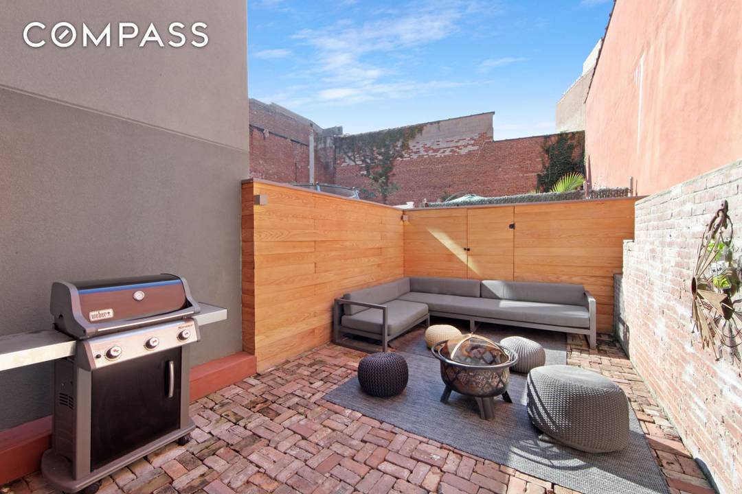 Loft 1C offers soaring double height ceiling height of nearly 17 feet, Southern exposed floor to ceiling windows, steel stairs railings, original exposed brick and a private backyard.