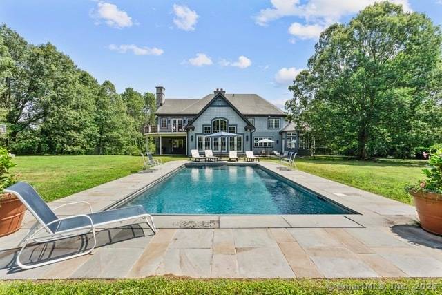 This stunning custom estate in Easton sits on over four private acres with a long tree lined driveway.