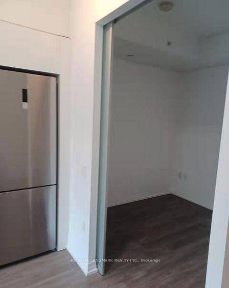 Bright and spacious split 2 bedroom unit with a locker, located at Dundas Square Gardens.