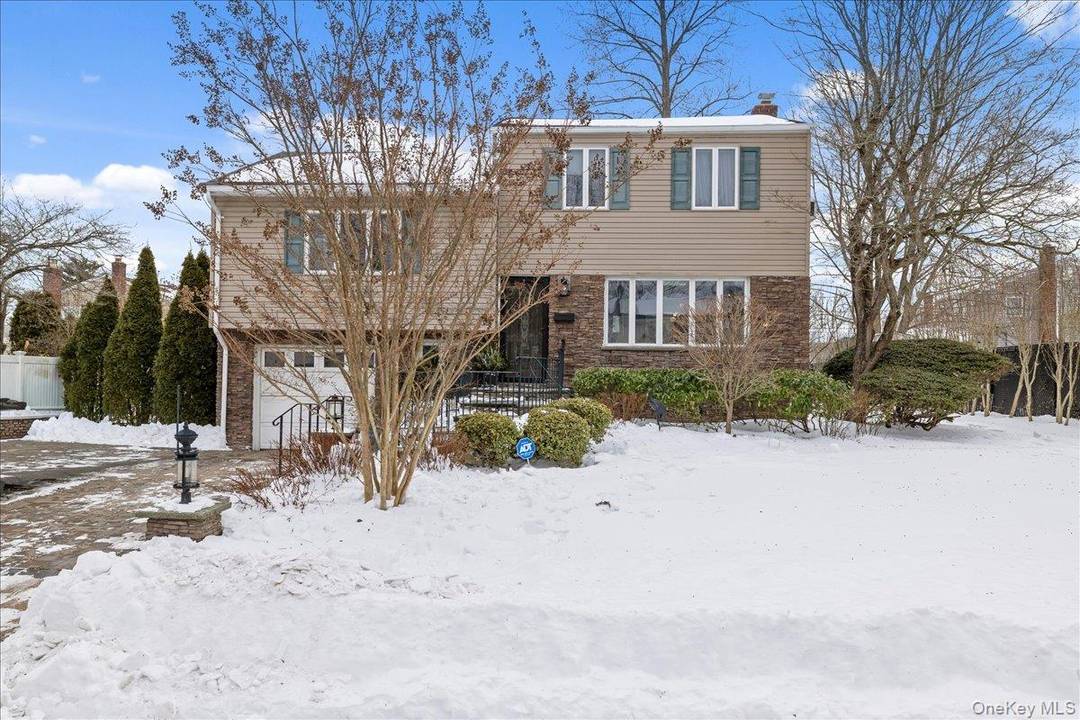 Welcome to this impeccably maintained split level residence, offering refined living in the highly coveted Plainview School District.