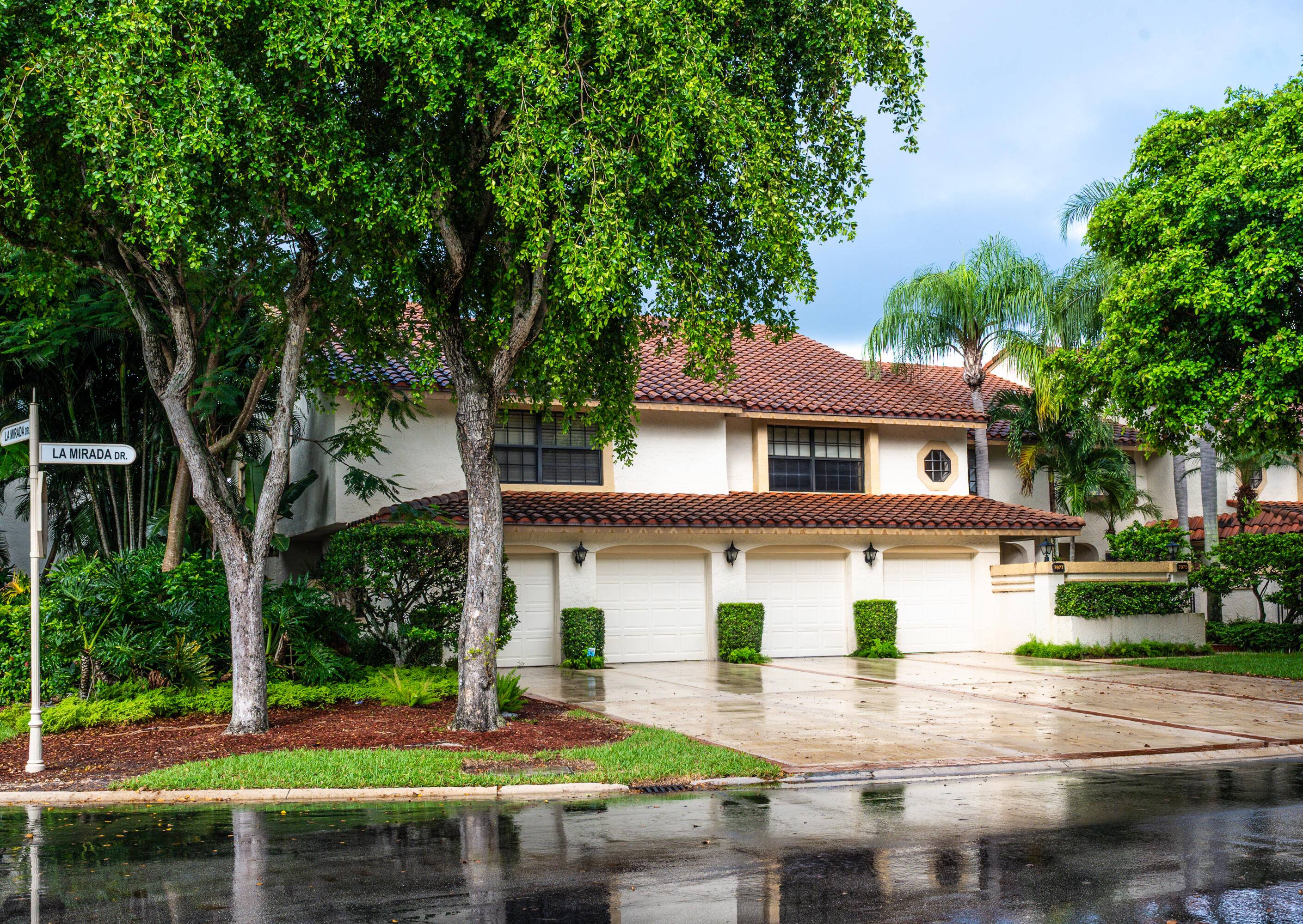 End unit villa in Boca Pointe's La Mirada with soaring ceilings, impact glass enclosed lanai, and serene waterfront views.