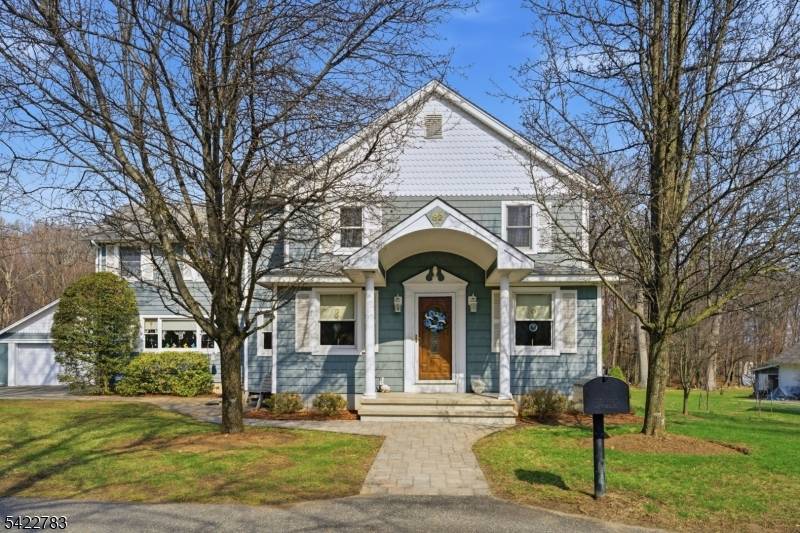 Set on over three acres of beautifully level land, this distinctive Colonial offers space, versatility, and timeless charm.