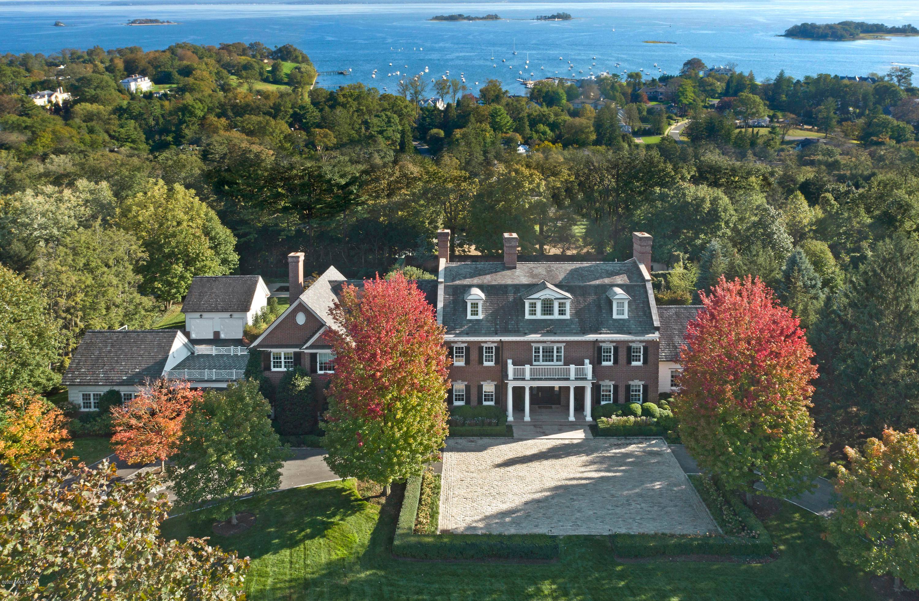 Magnificent brick Georgian home blends modern living with classic elegance on a private lane in Belle Haven area.