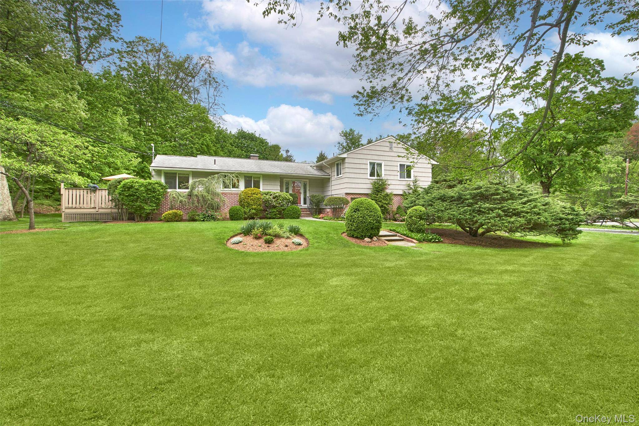 Set on nearly an acre of beautifully landscaped property in a quiet cul de sac, this updated four bedroom, three and a half bathroom Contemporary split level home offers bright, ...
