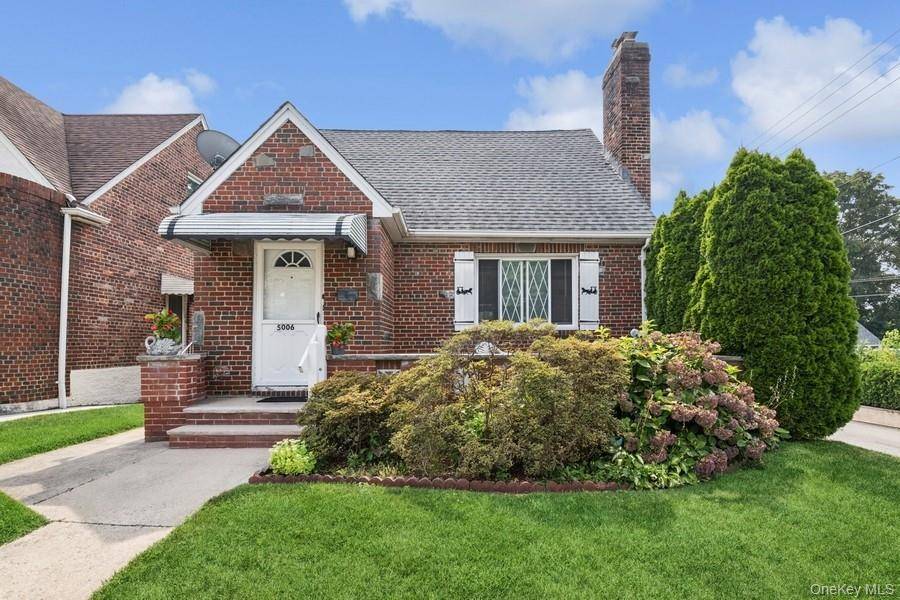 Charming All Brick Cape Cod with Front Porch and a Beautiful Backyard !
