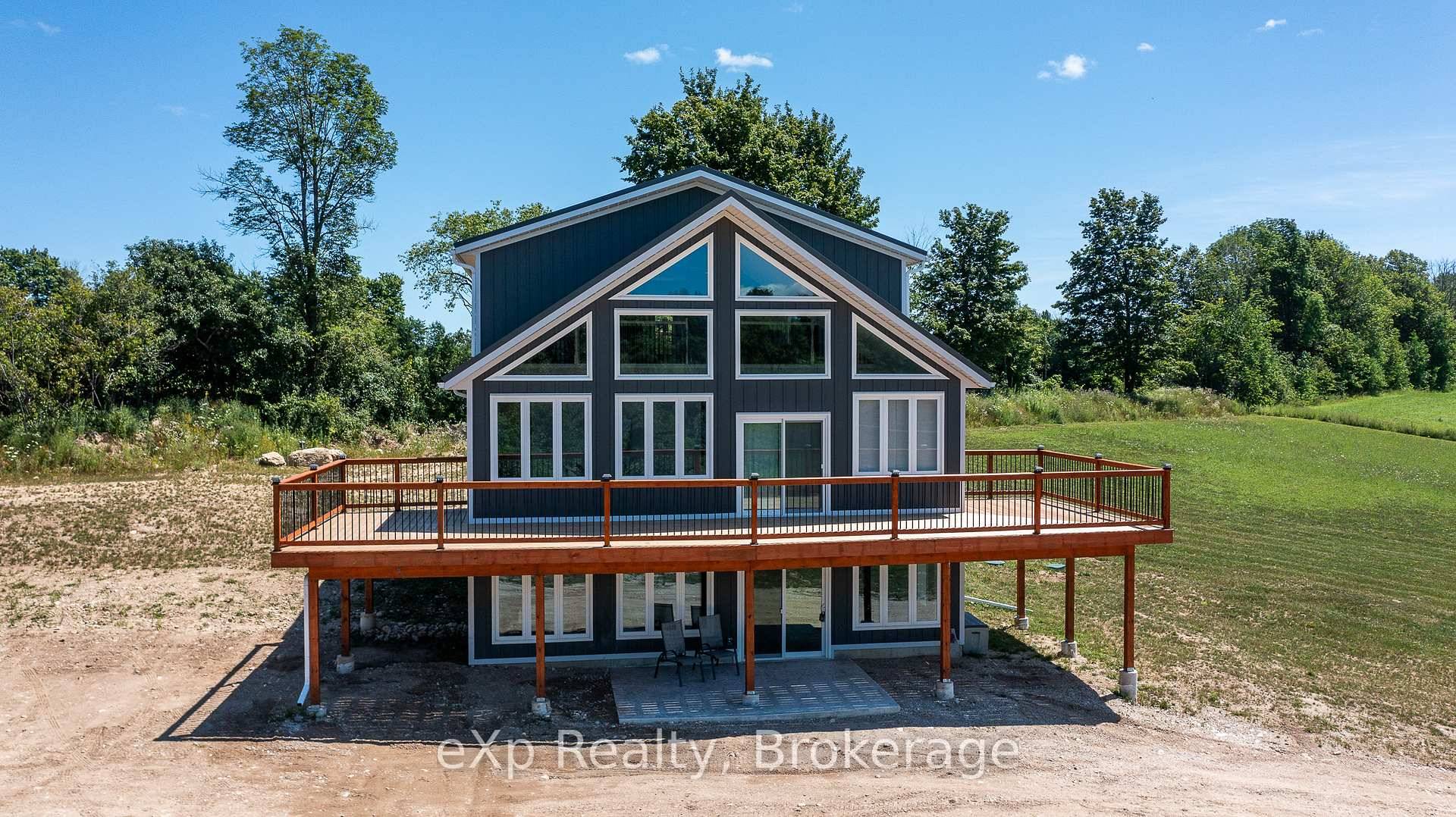 Nestled atop a hill, this elegant new home is set on just under 5 acres.