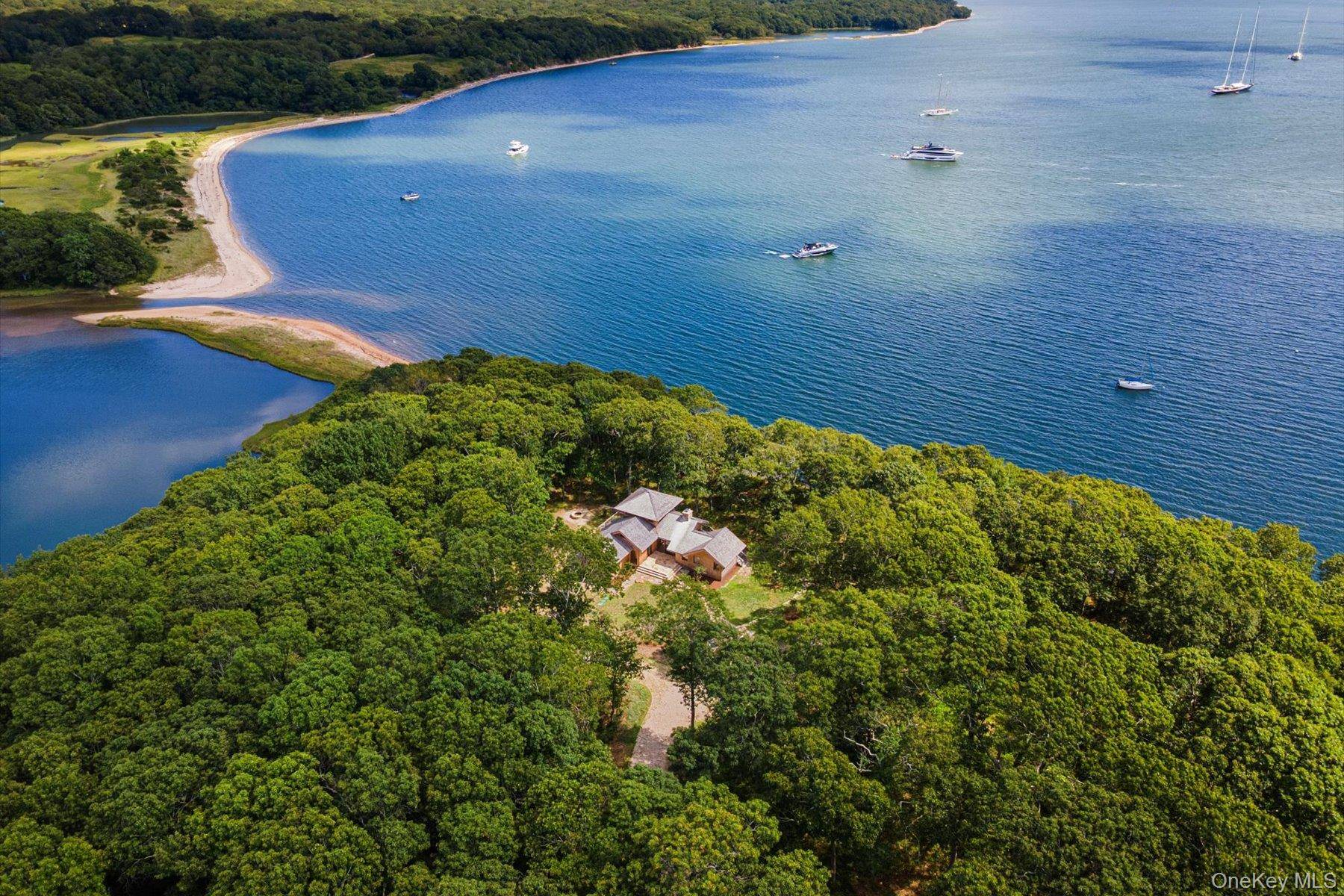 Perched 59 feet above sea level for commanding views and peace of mind, this exceptional contemporary estate designed by noted architect Kenton van Boer rests on 9.