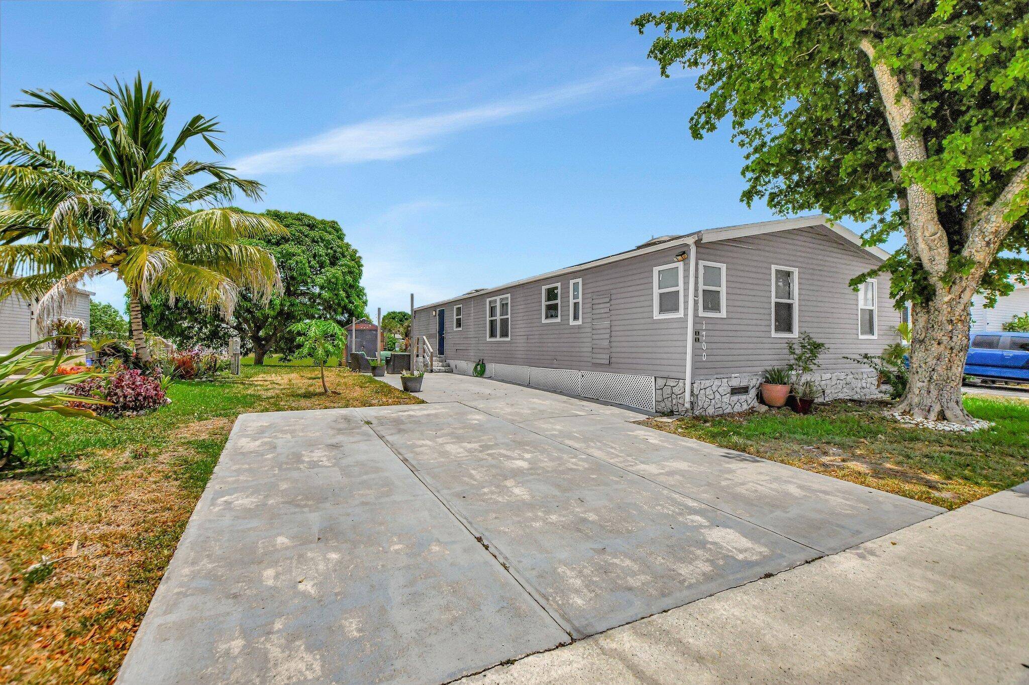 This exceptional residence in highly sought after West Boca Raton presents a spacious four bedroom, two bathroom home designed for both comfort and security.