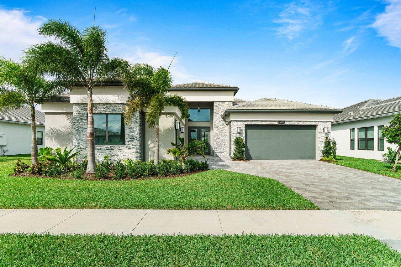 Stunning 4 BD 4 BA home on the lake in the prestigious Valencia Grand of Boynton Beach.