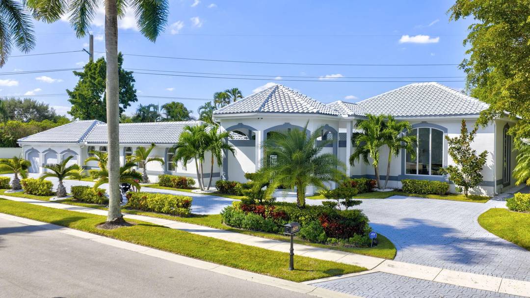Experience refined luxury living in this spectacular single story estate home, ideally located in the prestigious Village of Grand Oaks within the exclusive Broken Sound Country Club.